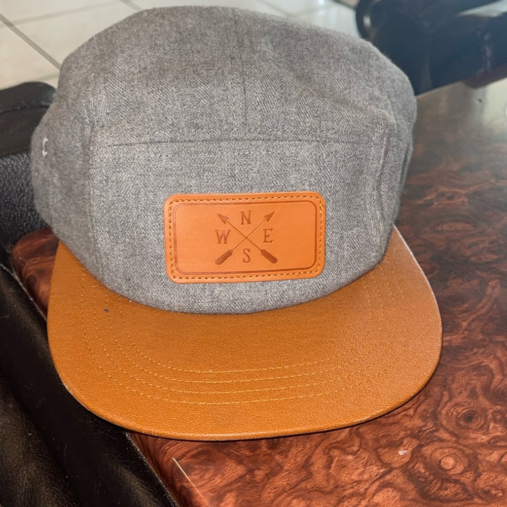 Brown pleather  and grey north east west south snap back hat